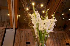 white flowers in a clear vase on a table