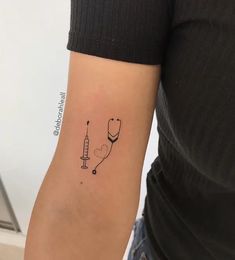 a woman's arm with a tattoo on it that has a stethoscope attached to it