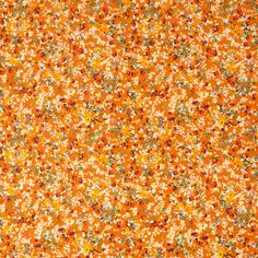 an orange and white flowered fabric with many small flowers on the top of it