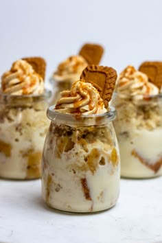 desserts in small glass jars with crackers on top