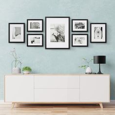 a living room scene with focus on the sideboard and pictures hanging on the wall