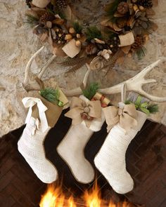 two stockings with bows are hanging on the fireplace