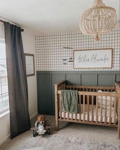 a baby's room with a crib, bed and window