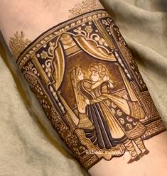 a woman's arm with a tattoo on it that has an image of two people