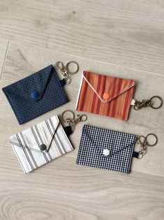 four different colored envelopes sitting on top of a wooden table