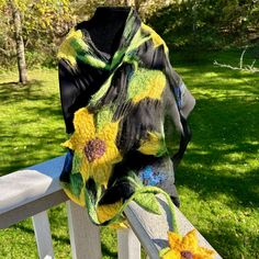 With this gorgeous sunflower scarf on sheer black silk, you'll stand out in the most fashion-forward way! Bright golds and yellows are punctuated with green stems and leaves and fluttering blue butterflies. At 18 inches wide and 73 inches long (including the 15-inch flowered tail) this is a great wrap to drape across your shoulders on a summer evening, when air conditioning sends you a chill, or when you need a dose of summer on the coldest day! These bright blooms will bring you hope as they did when Susan B. Anthony and Elizabeth Cady Stanton chose them as the symbol of the suffragist cause.  Please remember that your monitor and mine may be on different color wavelengths. These are eye-poppingly beautiful colors, but they might not precisely match what you see on your screen. LAUNDER by Black Summer Shawl Scarf, Black Shawl Scarf For Summer, One Size Black Scarves For Spring, Black One Size Scarves For Spring, Black One-size Scarves For Spring, Black One Size Summer Scarves, Black Bohemian Scarf For Summer, Black Bohemian Summer Scarf, Elizabeth Cady Stanton