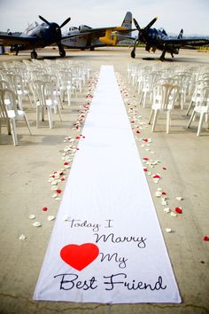 a long white aisle with red hearts on it and an airplane in the background that says, today i want to be my best friend