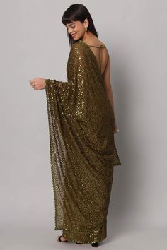 Unveil the allure of the night with our Mehandi Sequins Embroidery Georgette One Minute Saree. In the enchanting shade of Olive Green, this saree isn't just a garment; it's a enchanting story woven in Georgette, adorned with a mesmerizing cascade of Heavy Sequins that shimmer like stars in the midnight sky. No trims needed when the saree itself is a masterpiece. The blouse, crafted from the same fabric, features thin straps and a Deep U neckline, ensuring you're draped in sheer elegance that lea Reception Sarees, One Minute Saree, Formal Saree, Saree With Belt, Floral Print Sarees, Saree Sale, Sarong Skirt, Ruffle Saree, Party Wear Saree