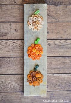 buttons are arranged on a piece of fabric to make a button board for the sewing project