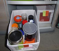 an open refrigerator door with various items in the bins and on the shelf next to it