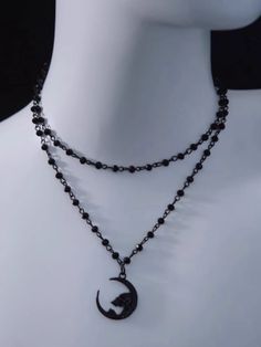 Unveil your dark elegance with our Gothic Moon Pendant Necklace. This exquisite necklace features a striking moon pendant, intricately designed to capture the essence of gothic allure. Crafted with meticulous attention to detail, the beads create a captivating contrast against the ethereal moon pendant. Gothic Adjustable Necklace With Moon Charm, Black Gothic Moon Phase Necklace, Gothic Black Moon Phase Necklace, Black Moon Shaped Jewelry For Halloween, Black Moon-shaped Jewelry For Halloween, Black Moon-shaped Halloween Jewelry, Gothic Black Jewelry With Moon Phase, Gothic Black Moon Phase Jewelry, Black Moon Charm Jewelry For Halloween