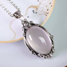 "48x25mm Natural Rose Quartz Pendant Oval Cut, Excellent Rose Quartz Pendant Necklace, 925 Sterling Silver Setting With a vibrant rose color this natural rose quartz is set into a 925 Sterling Silver pendant setting. The stone is of excellent quality and cut, it has no natural visible inclusions and an even coloration. The color is deep and not faint. Perfect for everyday wear and even special occasions. This pendant comes with a 18inch (45cm) chain as shown on the pictures. Details Stone: Natural Rose Quartz Size: 48x25x16mm Pendant weight：23.3g Metal: 925 Sterling Silver Chain Length: 18\" / 45cm This item is in stock and ready to be shipped. It comes in a lovely gift box and is shipped with FedEx Express Delivery." Silver Oval Rose Quartz Jewelry, Oval Rose Quartz Silver Jewelry, Raw Rose Quartz Necklace, Rose Quartz Pendant Necklace, Pink Gemstone Necklace, Rose Quartz Necklace Pendants, Quartz Pendant Necklace, Rose Quartz Jewelry, Amethyst Necklace Pendant