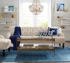 a living room filled with furniture and a chandelier