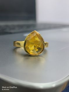 Yellow sapphire, also known as "Pukhraj" in Hindi, is a gemstone that belongs to the corundum family, just like blue sapphire. It is the yellow variety of corundum and is valued for its vibrant yellow color. Yellow sapphire is composed of aluminum oxide (Al2O3) with traces of iron that give it its yellow hue. The color of yellow sapphire can range from pale yellow to intense golden yellow. The most prized and valuable yellow sapphires typically exhibit a pure, vibrant yellow color without any hi Ring For Man, Cultural Beliefs, Vedic Astrology, Light Reflection, Yellow Sapphire, Pale Yellow, Ring For Women, Ring Handmade, Rings Statement