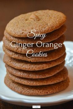 a stack of cookies on a plate with the words spicy ginger orange cookies above it