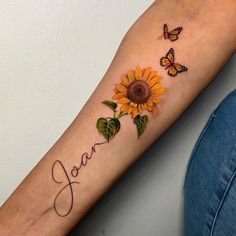 a woman's arm with a sunflower and butterflies on it that says joy