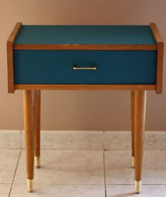 a wooden table with a blue drawer on it