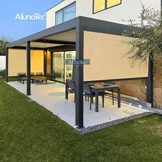 a modern house with an outdoor dining area