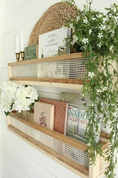 two wooden shelves with books and flowers on them