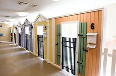 a row of lockers with doors and numbers on them in an empty hallway between two buildings