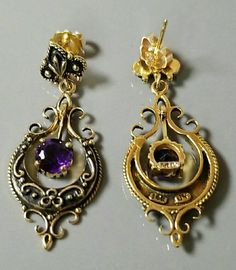 Pair of marked 14K yellow gold drop and dangle style vintage pierced earrings, with a post and friction fit back for fastening. Stunning regal earrings! Each earring is set with one round faceted beautiful purple amethyst gemstone. Each amethyst measures approximately 6.00 mm x 6.00 mm. Each amethyst is attached to a moveable design in the center of each earring. The pair of 14K yellow gold amethyst earrings are accented with black enamel, highlighting the 14K yellow gold scroll design and ameth Victorian Hallmarked 14k Gold Earrings, Antique Hallmarked 14k Gold Earrings, Vintage Yellow Gold Teardrop Earrings, Vintage 14k Gold Dangle Earrings, Heirloom Earrings For Formal Occasions, Vintage Pierced Earrings In 14k Gold, Vintage Pierced 14k Gold Earrings, Antique 14k Gold Dangle Earrings, Antique Yellow Gold Earrings Stamped 14k