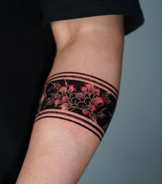 a person with a black and red tattoo on their arm