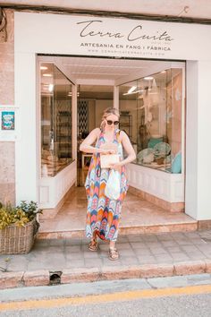 a woman standing in front of a store