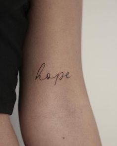 the word hope written in cursive writing on someone's lower back leg