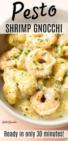 a bowl of pasta with shrimp and cheese in it, on top of a pink table cloth