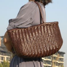 This woven leather handbag is spacious. 'Viviana' tote that's perfect for everyday use. It features soft yet durable vegetable tan calf leather,  to keep every belonging organized. Handmade by experienced artisan. Vegetable tanned calf leather - soft and durable.  Use delicate cream to clean and care for the leather. Brown Basket Bag With Intrecciato Weave, Everyday Leather Basket Shoulder Bag, Everyday Leather Basket Bag, Leather Basket Shoulder Bag For Daily Use, Elegant Brown Straw Bag With Woven Leather, Brown Woven Leather Straw Bag With Double Handle, Brown Leather Straw Tote Bag, Brown Leather Tote Straw Bag, Leather Straw Bag With Intrecciato Weave