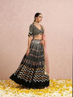 Featuring a black embroidered lehenga in silk base. It is paired with a black embroidered blouse and comes with a coral silk organza dupatta Color: Black and Coral Pink Fabric: Lehenga & Blouse - Silk base Dupatta - Silk Organza Note: The product will be shipped within 30-35 days of order placed Wash care - Dry Clean Only. Do not use heavy Iron Black Silk Fabric With Zari Embroidery, Black Silk Embroidered Fabric For Diwali, Black Silk Embroidered Fabric For Festivals, Black Silk Fabric With Resham Embroidery, Black Cutdana Embroidered Fabric For Traditional Drape, Black Art Silk Lehenga For Eid, Black Silk Embroidered Fabric For Wedding, Eid Black Art Silk Lehenga, Black Art Silk Traditional Wear For Reception