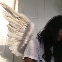 a woman with long hair and angel wings