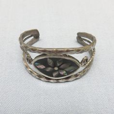 I found the nicest selection of vintage alpaca metal bracelets from a dealer here who was going out of business. Alpaca metal is an alloy of tin, copper, zinc and sometimes nickel that closely resembles real silver. These are beautiful long wearing pieces and a nice addition to any jewelry collection for very little money . This bracelet is very small. It is for a small child. Please note the measurements. This one is a open cuff with an inside diameter of 1 1/2 inches side to side by 1 1/8 inch Vintage Black Nickel-free Bracelets, Adjustable Silver Vintage Cuff Bracelet, Vintage Silver Adjustable Cuff Bracelet, Vintage Adjustable Silver Cuff Bracelet, Antique Adjustable Nickel-free Cuff Bracelet, Vintage Inlay Bracelets For Gifts, Vintage Bangle Cuff Bracelet With Inlay, Vintage Inlay Bracelets As Gift, Vintage Inlay Bracelets As A Gift