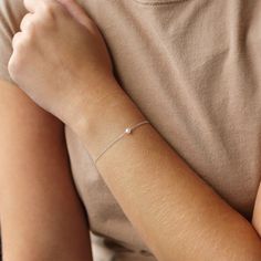 Dainty and classic, our Aura tiny pearl bracelet is a beautiful piece to wear everyday. Simple and timeless, you can wear it with everything.  P R O D U C T * D E T A I L S  - Pearl measures approximately 3.5mm - Available in Sterling Silver, 14k Gold Filled and 14k Rose Gold Filled - Each freshwater pearl is unique meaning the size and shape may vary - Wire wrapping detail - Available in Sterling Silver, 14k Gold Filled and 14K Rose Gold Filled L E N G T H - This bracelet is measured opened fro Minimalist Sterling Silver Pearl Bracelet With Charm, Classic Chain Bracelet With Pearl Charm As Gift, Classic Pearl Charm Chain Bracelet As Gift, Dainty Pearl Drop Beaded Bracelets As Gift, Dainty Sterling Silver Pearl Bracelet With Charm, Dainty Sterling Silver Bracelets With Pearl Charm, Dainty Sterling Silver Pearl Drop Bracelet, Minimalist Pearl Drop Chain Bracelet Gift, Minimalist Pearl Bracelet As A Gift