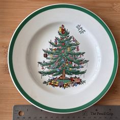 a plate with a christmas tree on it next to a measuring tape and a ruler