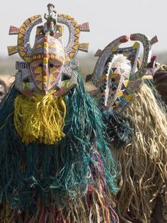 some people are dressed up in costumes and headdress for an event or festival