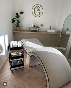 a spa room with white towels on the floor and various items in front of it