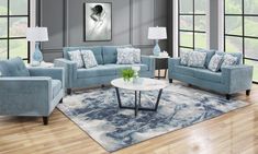 a living room with blue couches and chairs