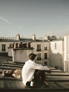 a man sitting on top of a roof