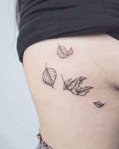 a woman's stomach with three leaves on the side and one in the middle