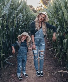 mother and daughter standing in corn field