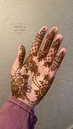 a woman's hand with henna on it