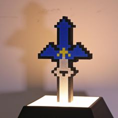 a blue and yellow pixel art piece sitting on top of a table