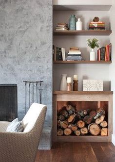 a living room filled with furniture and a fire place next to a wall mounted book shelf