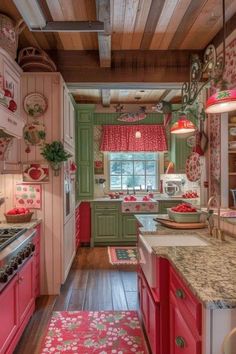 a kitchen with pink and green cabinets, wood floors and red rugs on the floor