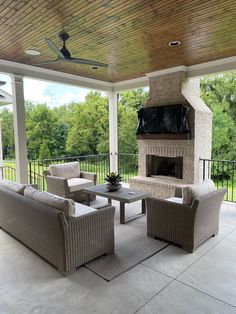 a covered patio with furniture and a fireplace