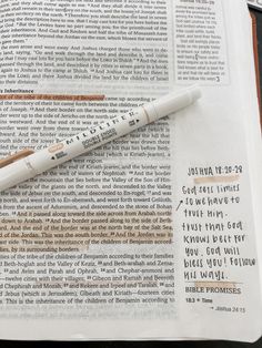 a pen sitting on top of an open bible