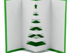 an open card with a green and white christmas tree