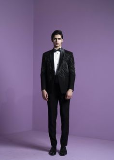 Sharp embroidered lines with cutdana work in shades of black and silver paired with tux sash. Tailored Embellished Suits For Gala, Luxury Embellished Suits For Gala, Luxury Embellished Party Suit, Embellished Tuxedo Suit For Party, Festive Embellished Tuxedo For Evening Events, Festive Embellished Tuxedo For Evening, Embellished Fitted Suits For Gala, Fitted Embellished Suits For Gala, Festive Embellished Evening Tuxedo