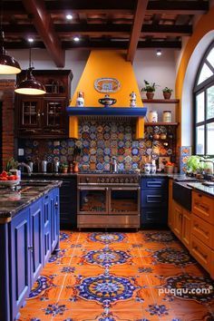 a kitchen with orange and blue tiles on the floor, counter tops and cabinets in it